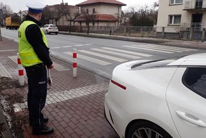 Policjant kontroluje rejon przejścia dla pieszych.