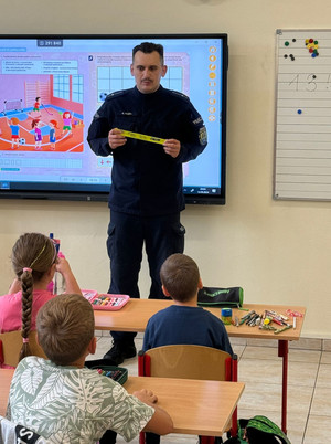 Na zdjęciu widoczny policjant podczas spotkania z dziećmi.