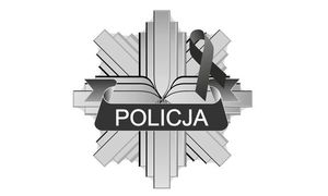 Policyjna gwiazda z napisem: Policja oraz kirem.