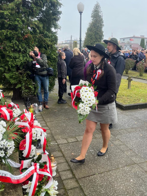Na zdjęciu widoczna delegacja harcerzy przed pomnikiem. Harcerka składa kwiaty.