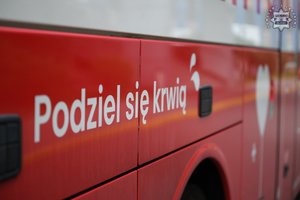 Na zdjęciu widoczny częściowo mobilny punkt poboru krwi oraz napis na nim: Podziel się krwią.