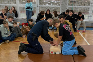 Na zdjęciu widoczny policjant, podczas spotkania z uczniami szkoły podstawowej.