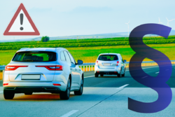 Na zdjęciu widoczne dwa jadące samochody, a po prawej stronie symbol paragrafu.