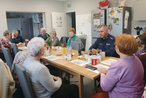 Policjant na spotkaniu z seniorkami.